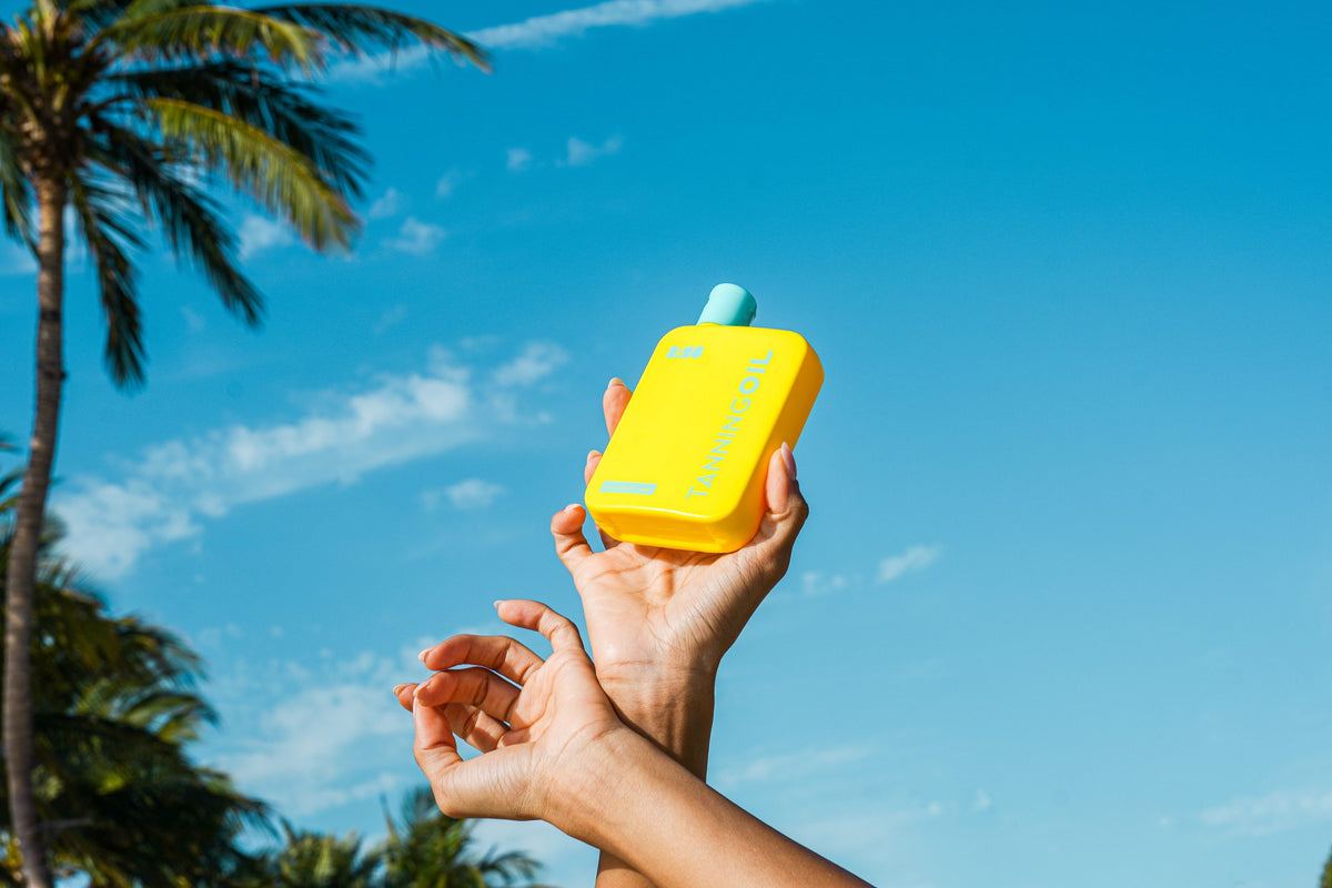 8:50 Tanning Oil held up to a blue sky