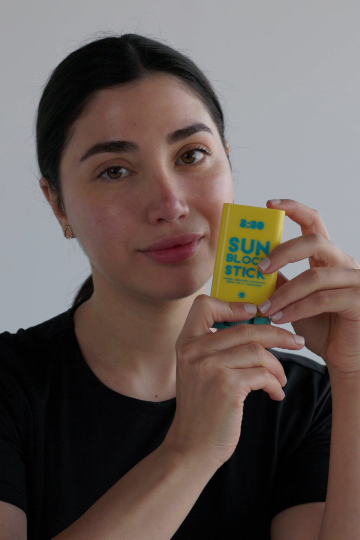 Holding 8:50 Sun Block Stick